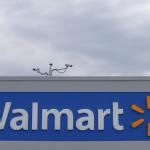 Photo of the top of a building with the logo for Walmart front and center.