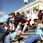 Other-abled protesters crawling up the steps of the Capitol