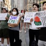 Photo of people rallying with signs like SAVE EPA.