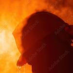 Image of a man's head with a hard hat and a hot sun.