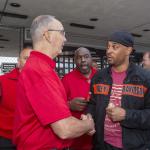 Photo of UAW president handshaking and talking to a worker.rkesr