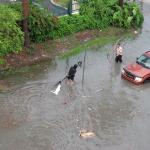 People try to pass through a flooded street in Miami Beach. 