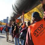 Keystone XL protesters carry a replica pipeline. 