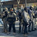 Photo of federal agents on the street in full armor and masksn 