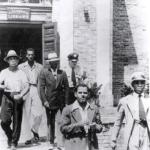 5 arrested demonstrators being escorted out of a Jim-Crow library