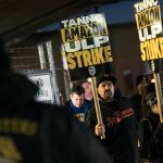 photo of striking workers holding signs.