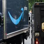 Photo of an Amazon truck next to a UPS truck. 