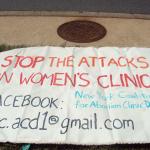 banner to stop violence against women's clinics