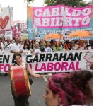Photo of the front of a huge ``march with banners and signs.