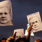 demonstrators with Assange photos