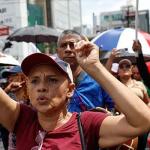 Marchers on the street with raised hands.