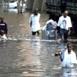 Hurricane Katrina victims in New Orleans wading through waist-deep floodwater