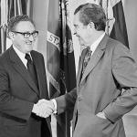 Henry Kissinger and Richard Nixon shaking hands in the Oval Office