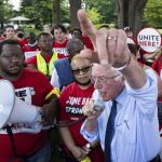 photo of bernie sanders with a bull horn in front of a crowd of UNITE HERE members