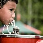 Latinx child drinking water