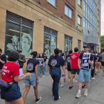Photo of people on a picket line with signs that say UAW on strike