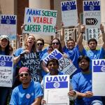 photo of workers holding signs - UAW 