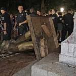 Police stand guard after Silent Sam was toppled at the University of North Carolina on Monday.