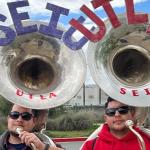 photo of two workers with tubas side-by-side with the acronyms of the two unions  :  SEIU and UTLA