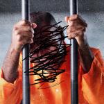 Photo of a man behind bars with his face crossed out with magic marker. 