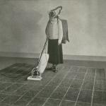 Woman vacuuming.