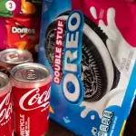In this photo illustration, food products manufactured by Mondelez and Coca-Cola are shown on December 11, 2024 in Chicago, Illinois. 