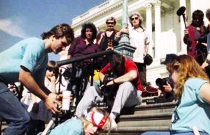 Other-abled protesters crawling up the steps of the Capitol