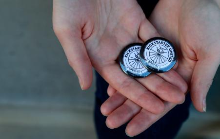 Hands holding Kickstarter United OPEIU buttons