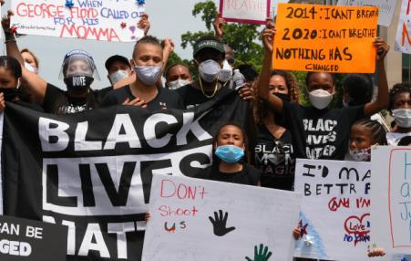 Workers at a rally with Black Lives Matter Signs