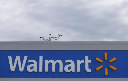 Photo of the top of a building with the logo for Walmart front and center.