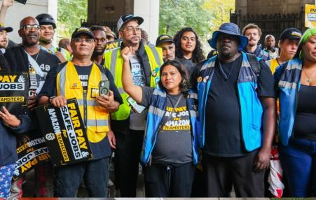 Photo of workers with signs reading "fair pay safe jobs"