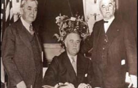 On May 20, 1936 Franklin Delano Roosevelt (center) signs the Rural Electrification Act. 