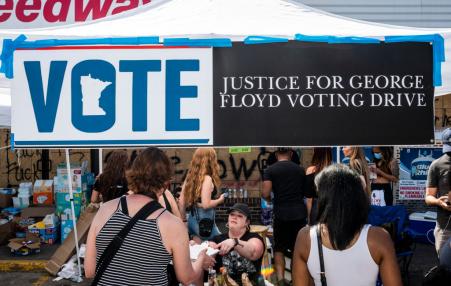 A voter registration booth at a memorial site for George Floyd.