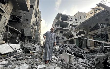 Older man waking amidst the rubble from bombing