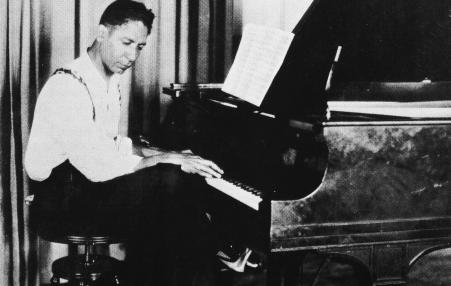 Composer Jelly Roll Morton at the piano keyboard
