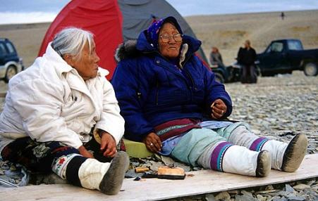 Inuit elders eating Maktaaq, a whale blubber delicacy.