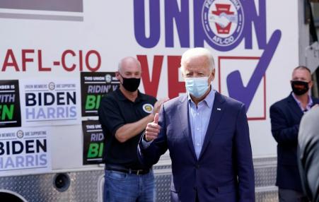 Biden in a mask with union members.