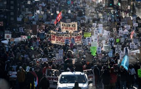 photo of protesters with signs against ICE