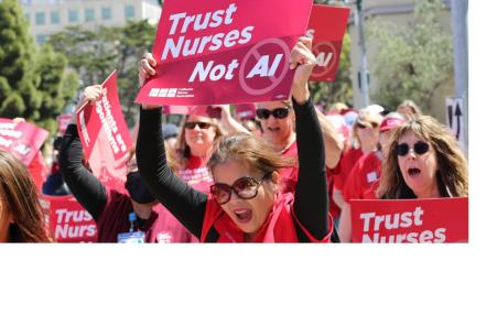 Photo of Nurses in red scrubs rallying .