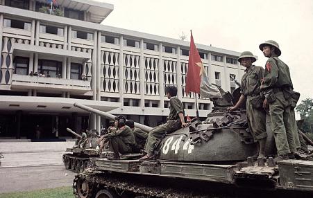 Two military tanks belonging to the People's Revolutionary Government stand outside the Saigon regime's headquarters building on April 30, 1975
