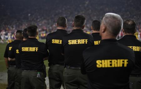 Sheriff’s deputies on the sidelines of a National Football League game.