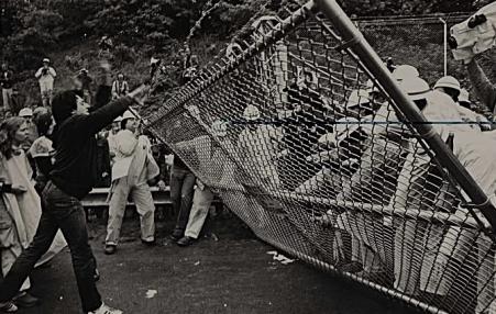 Anti-nuke demonstrators pulling down a fence at the Shoreham construction site