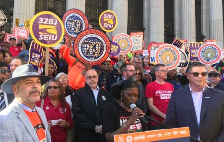 Photo of union leaders and members on the street with union signs