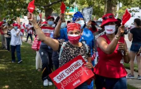 Photo of a group of nurses rallying with signs 