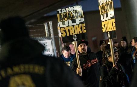 photo of striking workers holding signs.