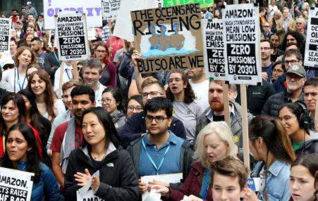 Photo of many people at a protest with signs.