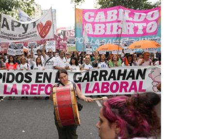 Photo of the front of a huge ``march with banners and signs.
