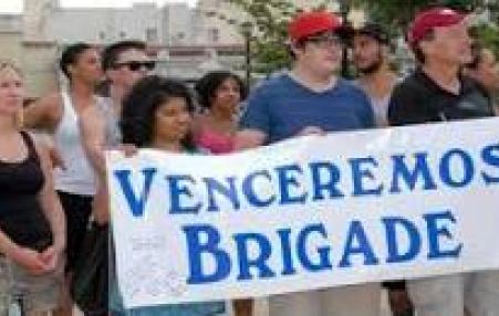 demonstrators holding Venceremos Brigade banner