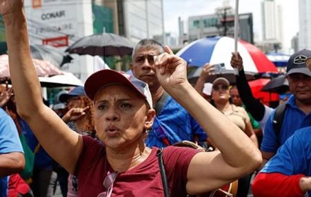 Marchers on the street with raised hands.