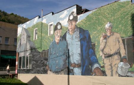 Photo of a painted mural of three coal miners.